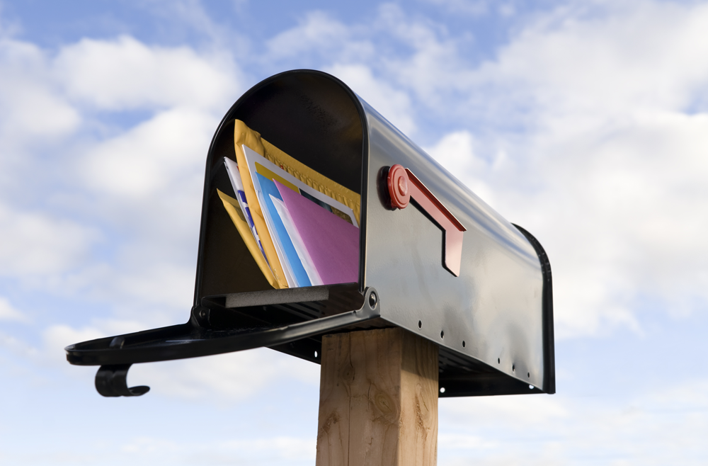 An open mailbox filled with letters.